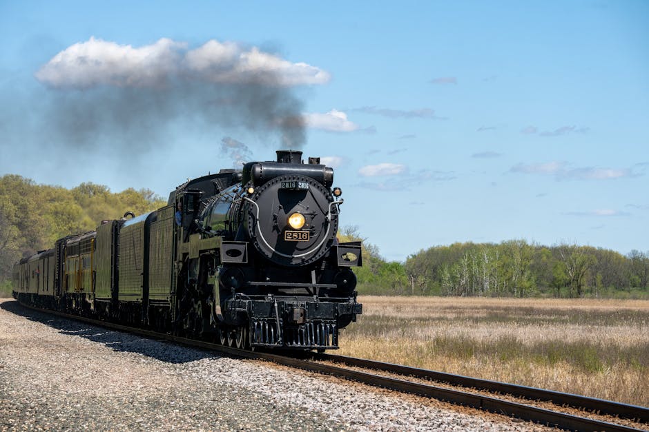 A classic steam train travels through the scenic rural landscape of Kellogg, Minnesota.